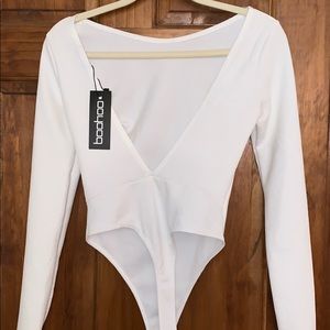 Brand new backless creme long sleeve bodysuit